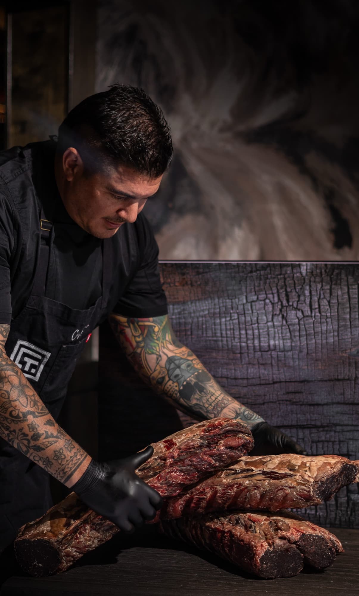 Executive Chef Juan Pablo Blanche with 45-day dry-aged cuts at Fuego Vivo